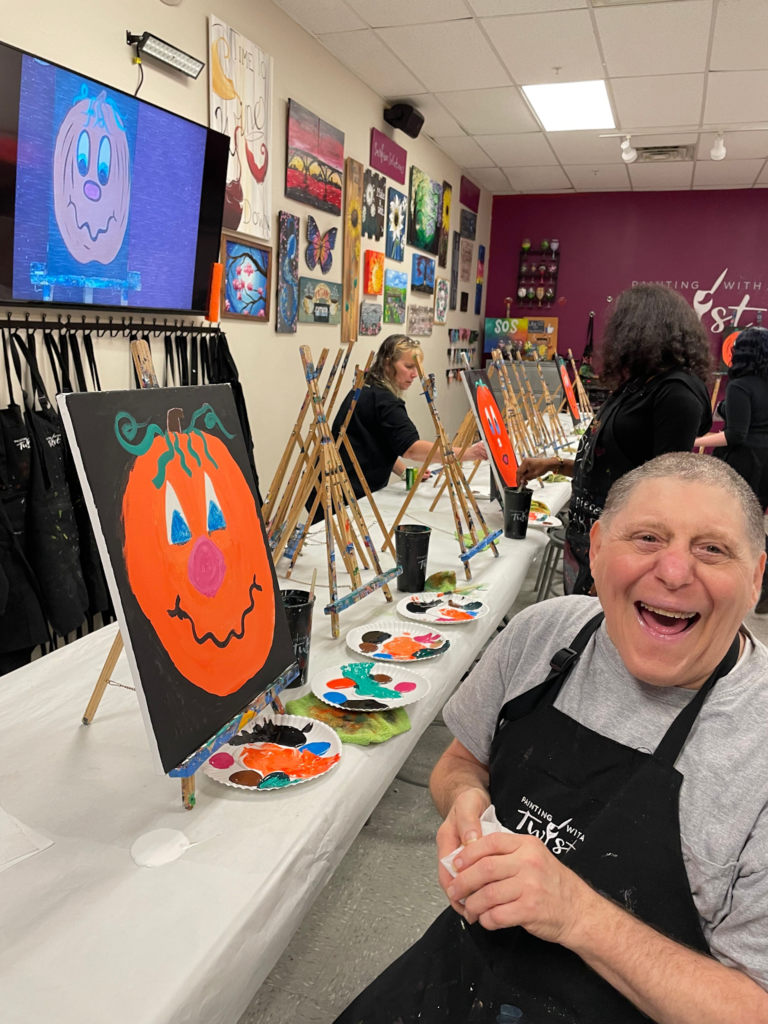 Resident enjoying Painting with a Twist activity